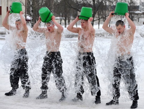 Belarussian interior troop soldiers pour cold water over themselves during an oath-taking ceremony in Minsk, on February 19, 2011. AFP PHOTO / VIKTOR DRACHEV (Photo credit should read VIKTOR DRACHEV/AFP/Getty Images)